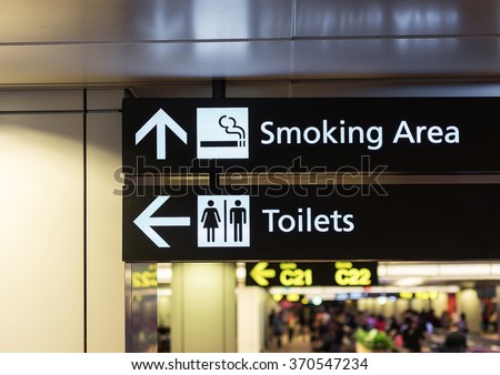 Toilets icon. Public restroom signs l and smoking area. Interior of airport terminal.