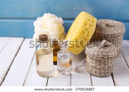 Spa setting. Bottles wit essential aroma oil  on  white wooden background. Selective focus.
