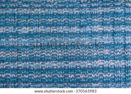 Knitted in stripes.Blue.Knitted manually.Closeup.Blue and white stripes.The horizontal location of the pictures.