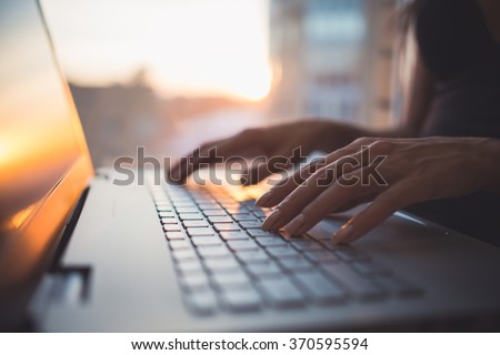 Woman working at home office hand on keyboard close up Royalty-Free Stock Photo #370595594