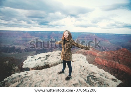 Travel hiking photo of young beautiful teenager student at Grand Canyon viewpoint when sunset, Arizona, USA