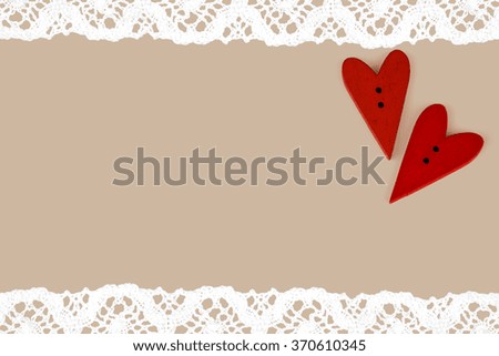 Red valentines hearts on neutral background with lace. Post card background for the Valentine.