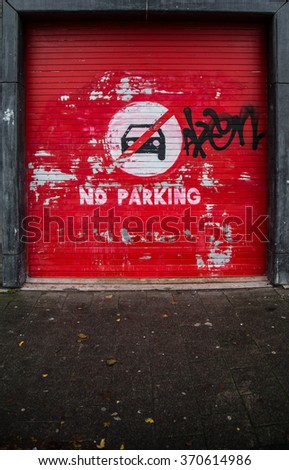 Abstract red garage door with caution sign of no parking