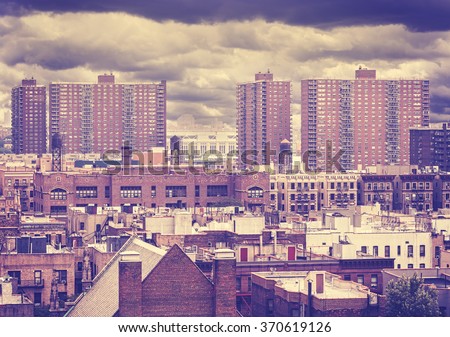 Vintage toned photo of New York residential buildings in rainy day, Harlem, USA.
