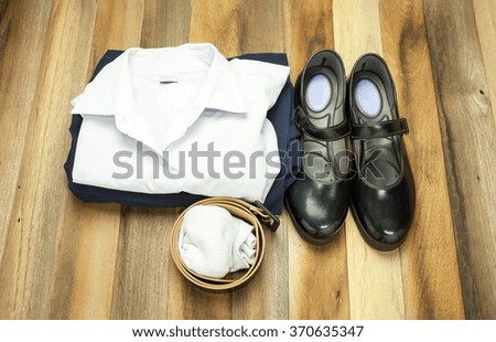 Still life : Thai Student girl uniform with wooden background on top view