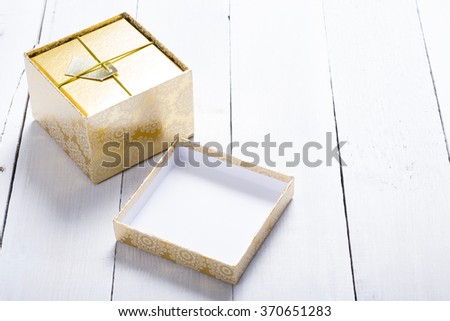 opened gift box on white wood table background