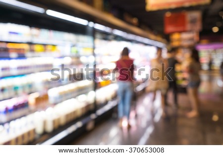 Blur of people buying with drinks  shelf product in Supermarket .Background for drinking market concept