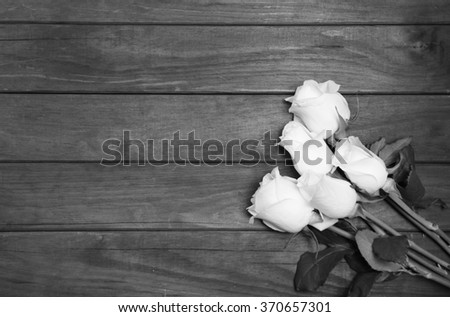 beautiful white roses on wooden background