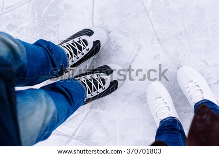 Woman and man  ice skating. winter outdoors on ice rink. ice and legs