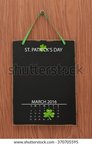 Saint Patrick's Day March 2016 Calendar Blackboard hanging on Wood Background
