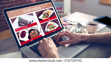 Food app against cropped hand of graphic designer using laptop