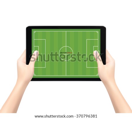 Hand holding touch screen tablet computer with soccer field background. Vector illustration.