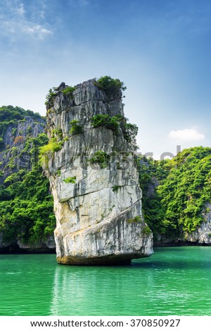 Scenic rock pillar and azure water in the Ha Long Bay (Descending Dragon Bay) at the Gulf of Tonkin of the South China Sea, Vietnam. The Halong Bay is a popular tourist destination of Asia.