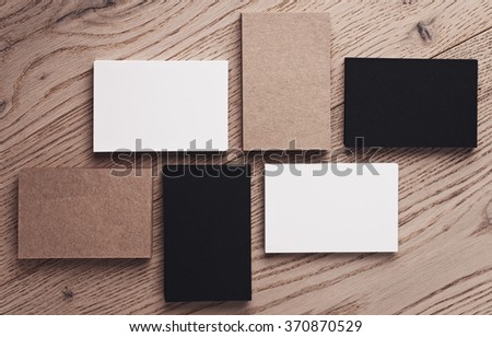 Set of white, black and craft business cards on wood table. Top view. Horizontal