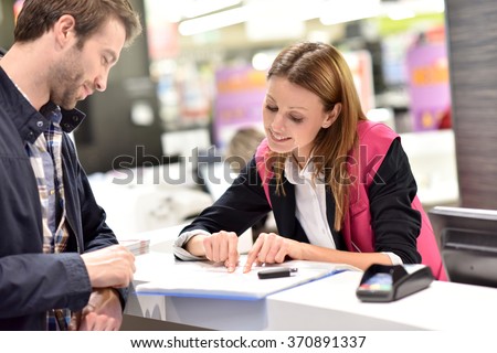 Car rental assistant giving information to customer Royalty-Free Stock Photo #370891337