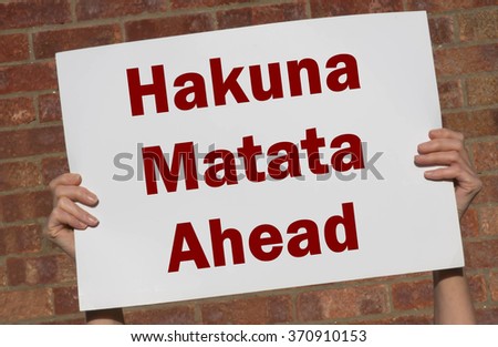 Hakuna Matata (Swahili phrase; it means "no worries") card against a brick wall background