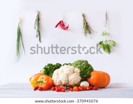 Collection of fresh vegetables on a white wooden table. 