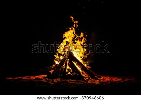 Night campfire in the middle Royalty-Free Stock Photo #370946606