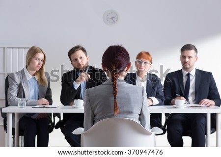 Woman during job interview and four elegant members of management Royalty-Free Stock Photo #370947476