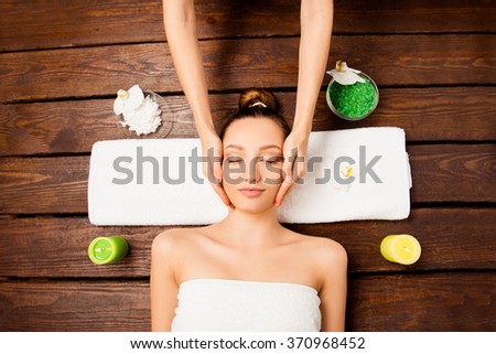 Attrative young girl having spa procedures in spa salon, top view photo