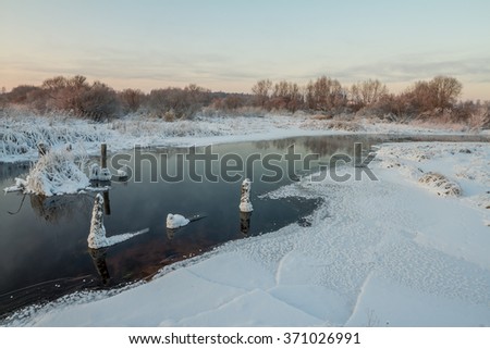 The frozen small river in the winter