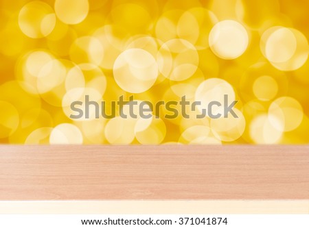 Wood table top on golden bokeh abstract background