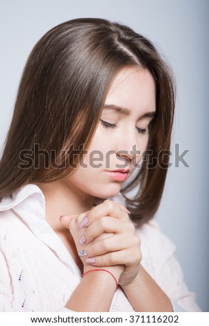 Business girl praying isolated on background
