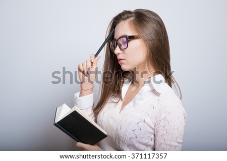 Business girl making notes in a notebook isolated on background