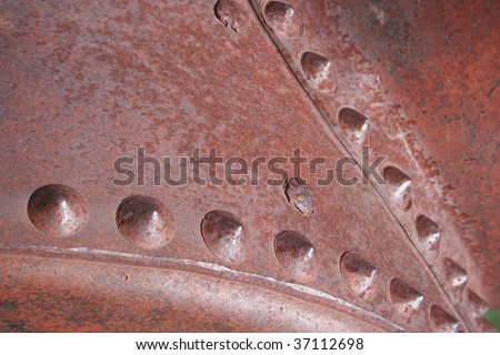 Closeup of Rusty Metallic Surface with Rivets