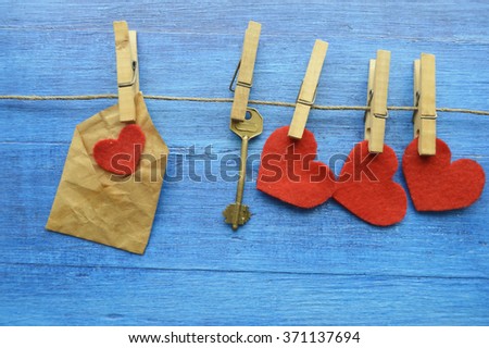 Valentine's Day.love concept, love confession.Happy valentine's day background with hearts hanging on rustic driftwood texture background,Love concept. Old key and a heart