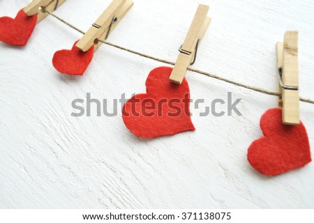 Valentine's Day.love concept, love confession.Happy valentine's day background with hearts hanging on rustic driftwood texture background,Love concept. Old key and a heart