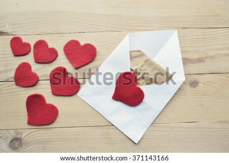 Valentine's Day.love concept, love confession.Happy valentine's day background with hearts.Envelope with a Heart Shapes.Love letter on a wooden background