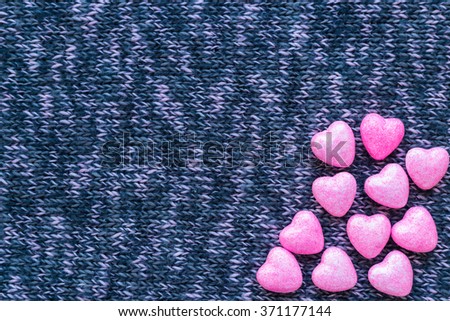 Little hearts on knitted surfaces. flat lay