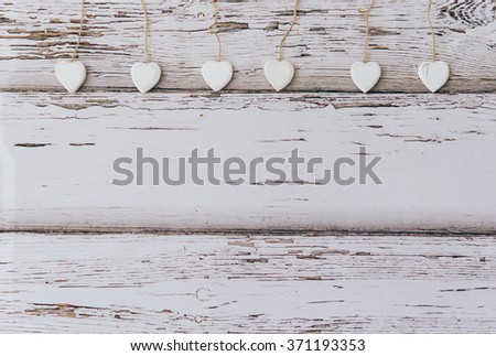 hearts hanging over grey rustic driftwood texture background, copy space