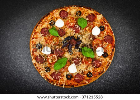 Pepperoni Pizza with Sausage, Cheese, Mozzarella, Olives and Basil Studio Photo