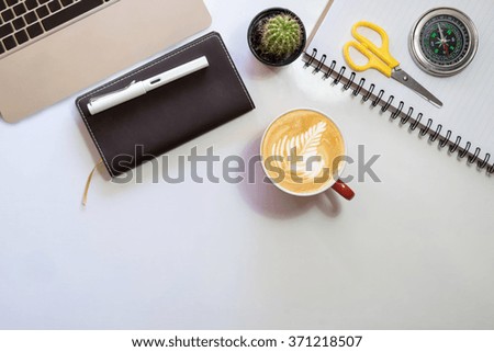 Top view of office supplies and gadgets on a work table,vintage tone.