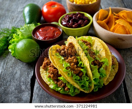 plate of tacos, nachos and tomato dip