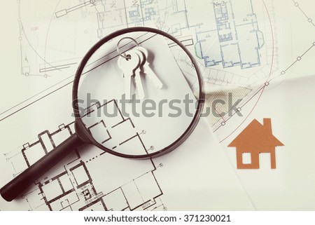 Model house, construction plan for house building, keys, divider compass and clipboard. Real Estate Concept. Top view