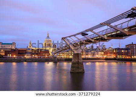 London skyline with St Paul's Cathedral and Millennium Footbridge at twilight in UK. 