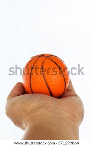 Toy basketball on hand isolated on white background