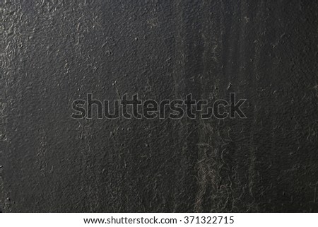 black painted metal surface with chipped paint