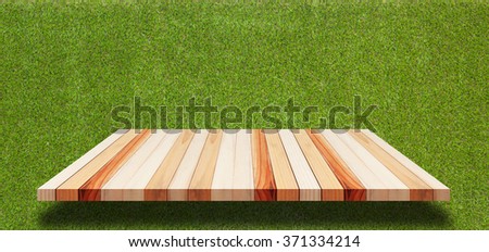 Empty wooden table on green pattern wall background - can be used for display products