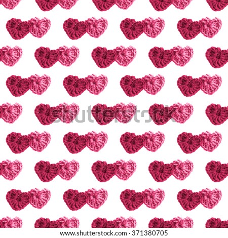 Two hand made crochet knit Red Heart and Pink Heart on white background. Valentines Day, Wedding knitting seamless pattern with hearts.
