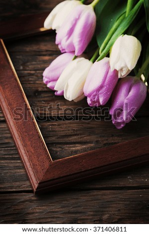 Bouquet of tulips on the wooden table, selective focus
