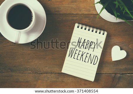 top view image of notebook with phrase: happy weekend, next to cup of coffee and little wooden heart. vintage filtered and toned
 Royalty-Free Stock Photo #371408554