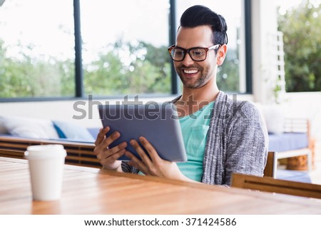 Smiling designer using tablet in the office