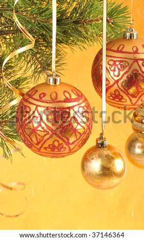 macro picture of red ball with garland on the fir tree