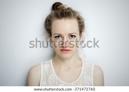 Young woman looking reproachfully into the camera