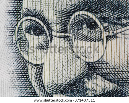 Mahatma Gandhi face on indian 100 rupee banknote extreme macro, India money closeup Royalty-Free Stock Photo #371487511