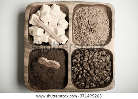 Different kinds of coffee on wooden plate on blue table. Toned.